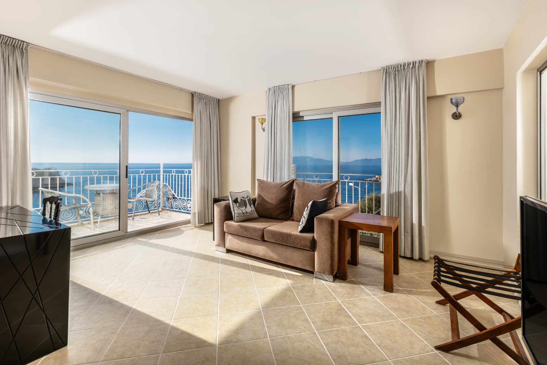 Bright suite living area with two sea-facing windows